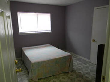 bedroom with box spring and window